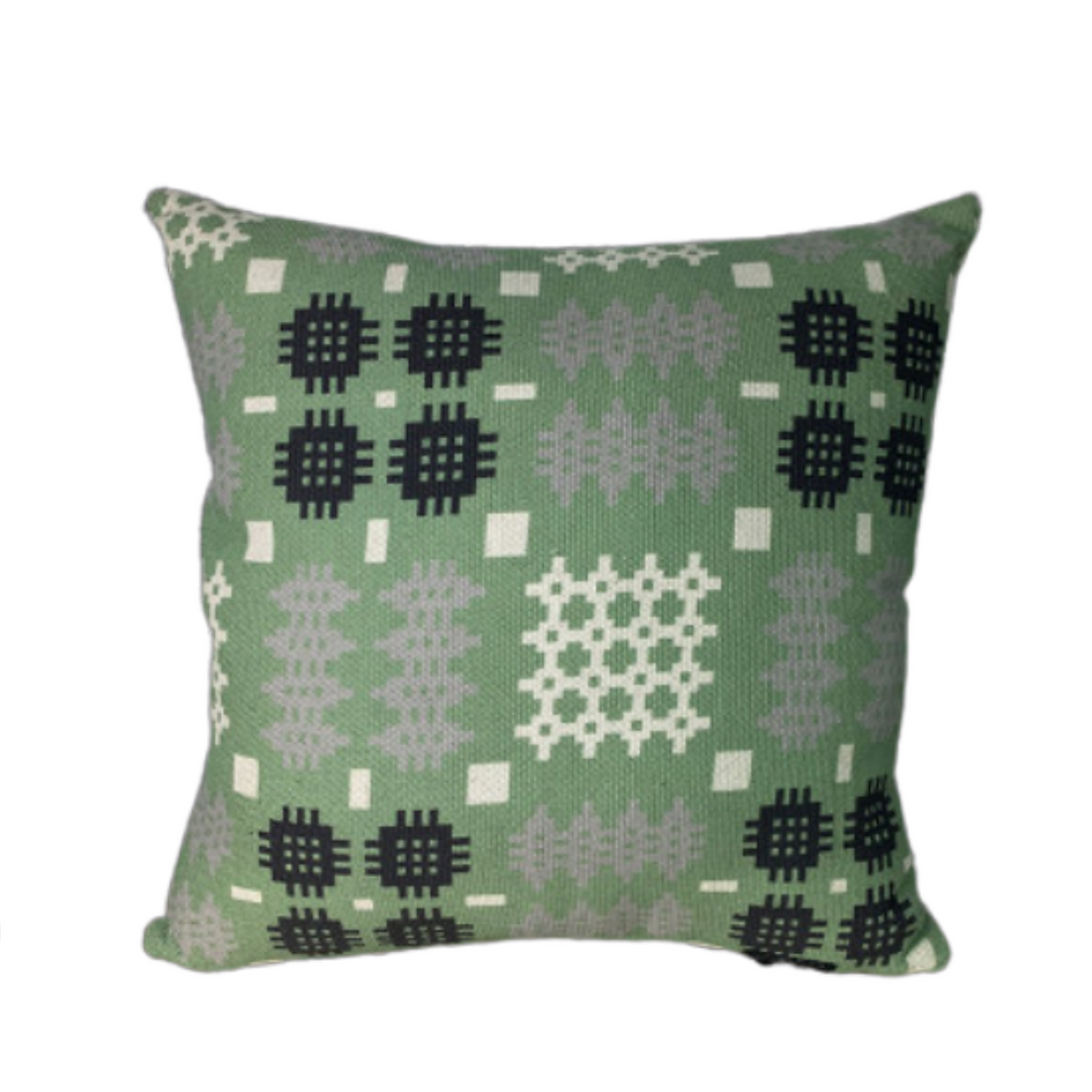 Image shows square shaped cushions in Pea green, mustard yellow and pale grey with traditional Welsh tapestry print design.