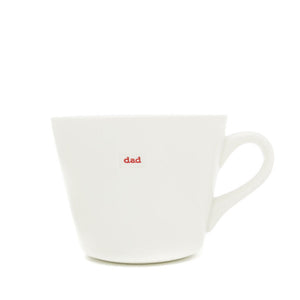 White simple bucket mugs with colourful lettering  in typewriter style font which read 'Dad','Bodlon','Mam,'Eisteddfod','Hapus','Taid','Siocled'.